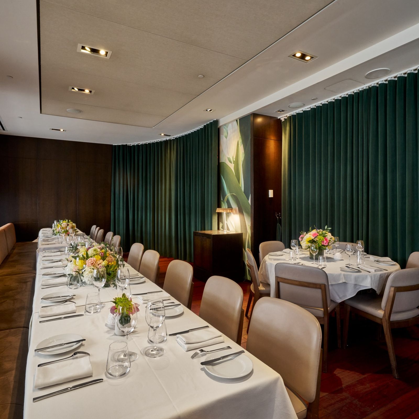 A long table lines a banquet to the left with a large round table to the right